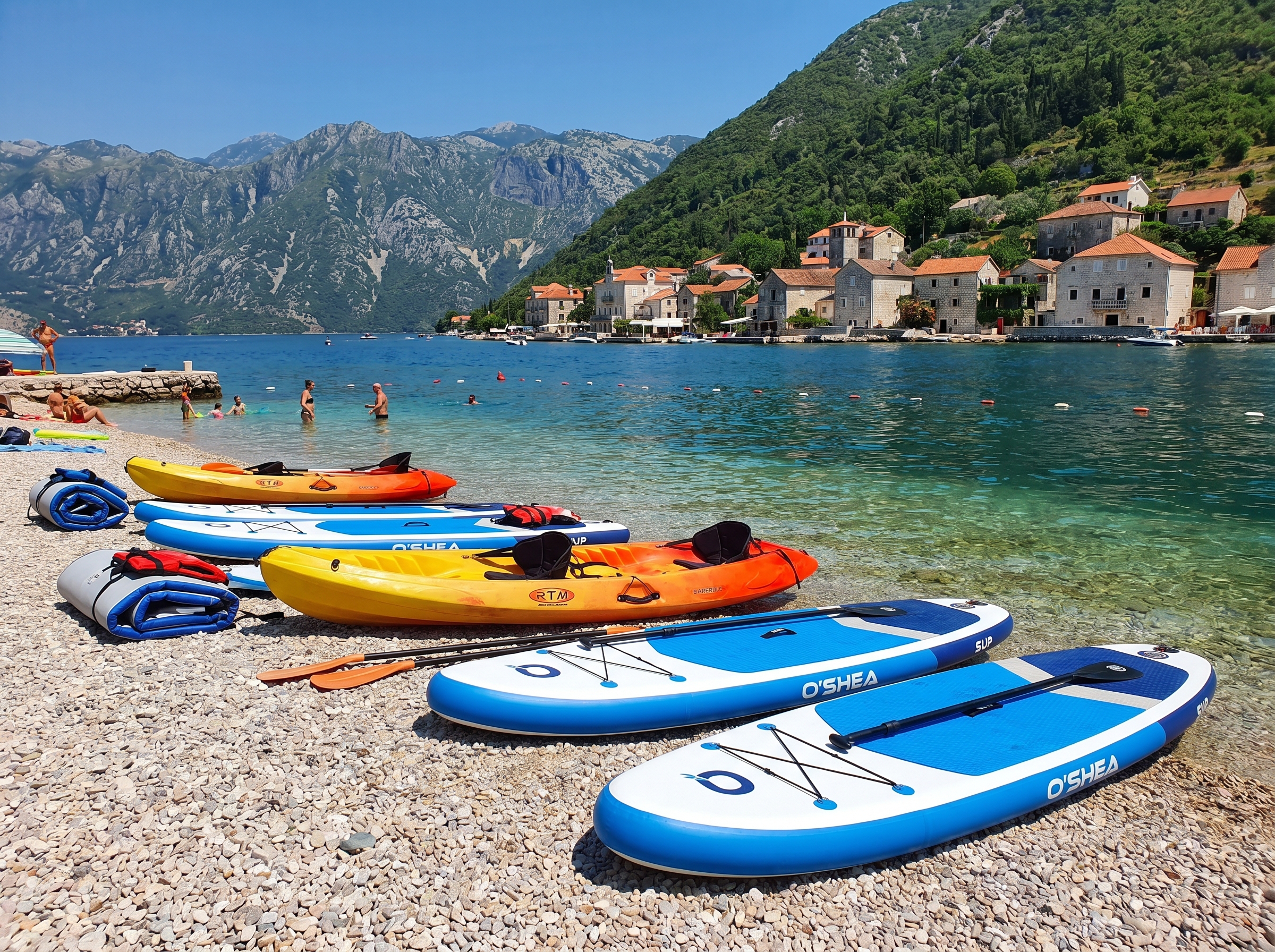 SUP boards and kayaks on the beach in Perast, Boka Bay