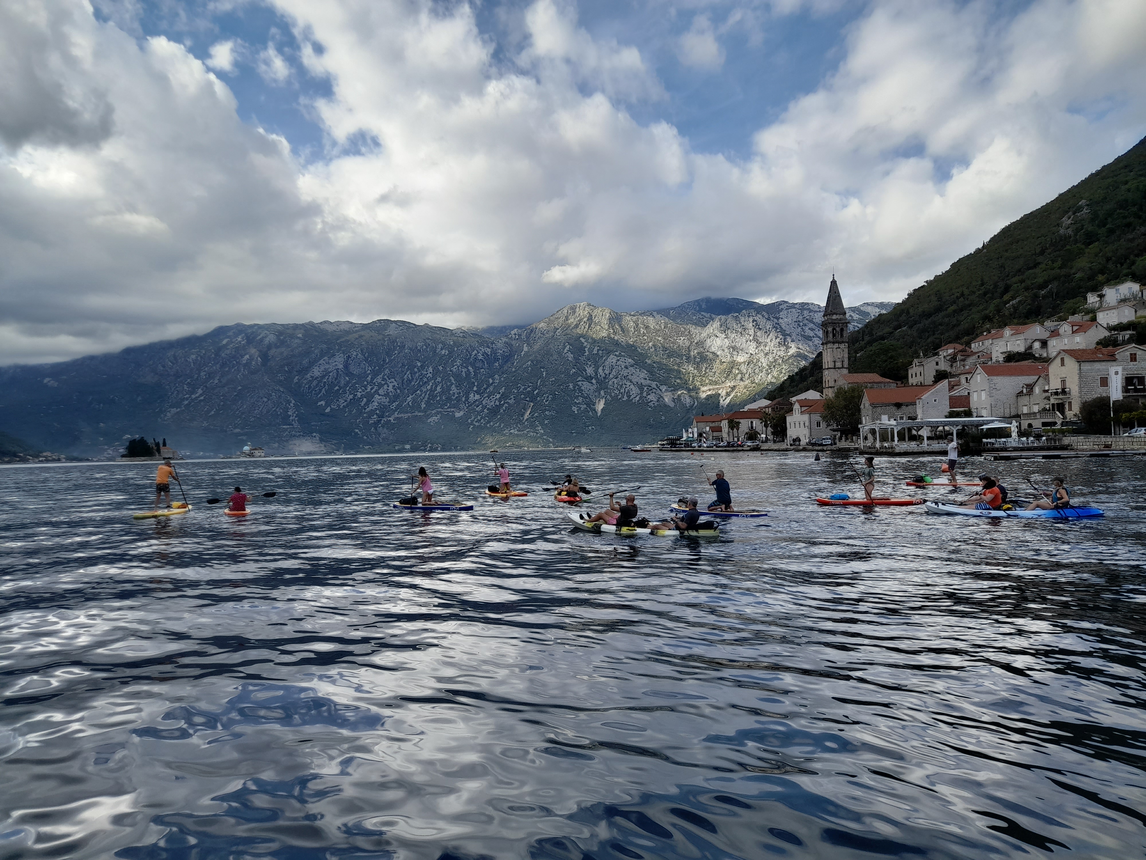 Big group on SUPs and kayaks off the Perast waterfront