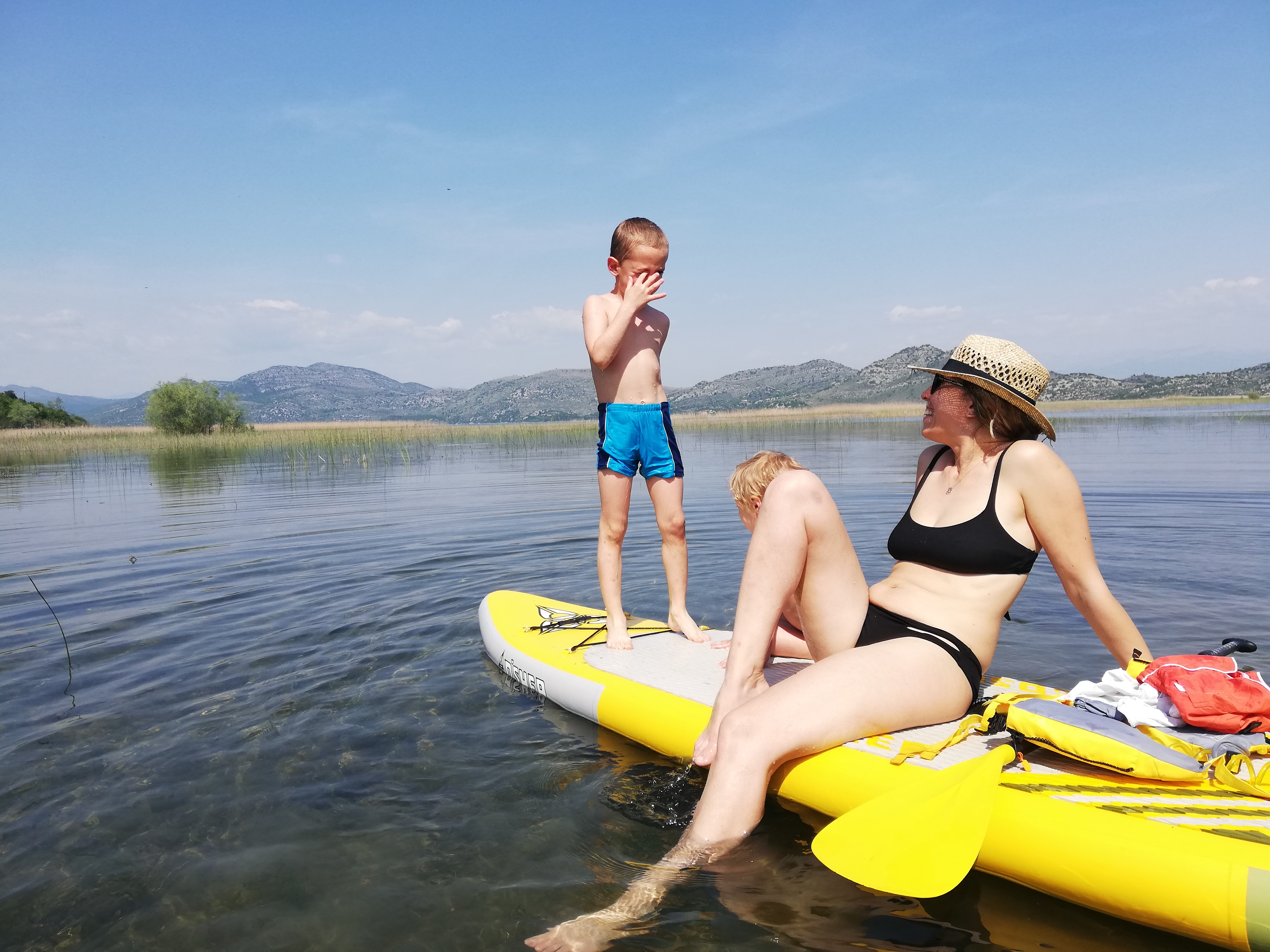 Family relaxing on a paddleboard on the open lake
